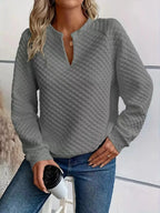 Women's plush fashion hub waffle-knit sweatshirt with notched raglan sleeves, soft textured pullover for casual comfort.