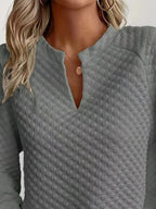 Women's notched raglan waffle-knit sweatshirt by Plush Fashion Hub featuring soft textured fabric and stylish raglan sleeves.
