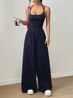 Casual women's summer jumpsuit by Plush Fashion Hub with wide-leg style, wrapped chest, and nipped waist, perfect for warm weather.