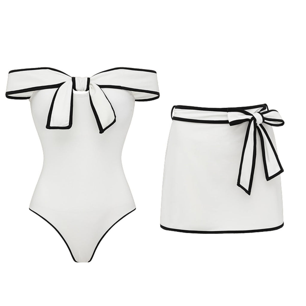 Black and white matching swimsuit bottoms with a sweet girl bow detail, featuring a white skirt, by Plush Fashion Hub.