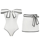 Black and white matching swimsuit bottoms with a sweet girl bow detail, featuring a white skirt, by Plush Fashion Hub.