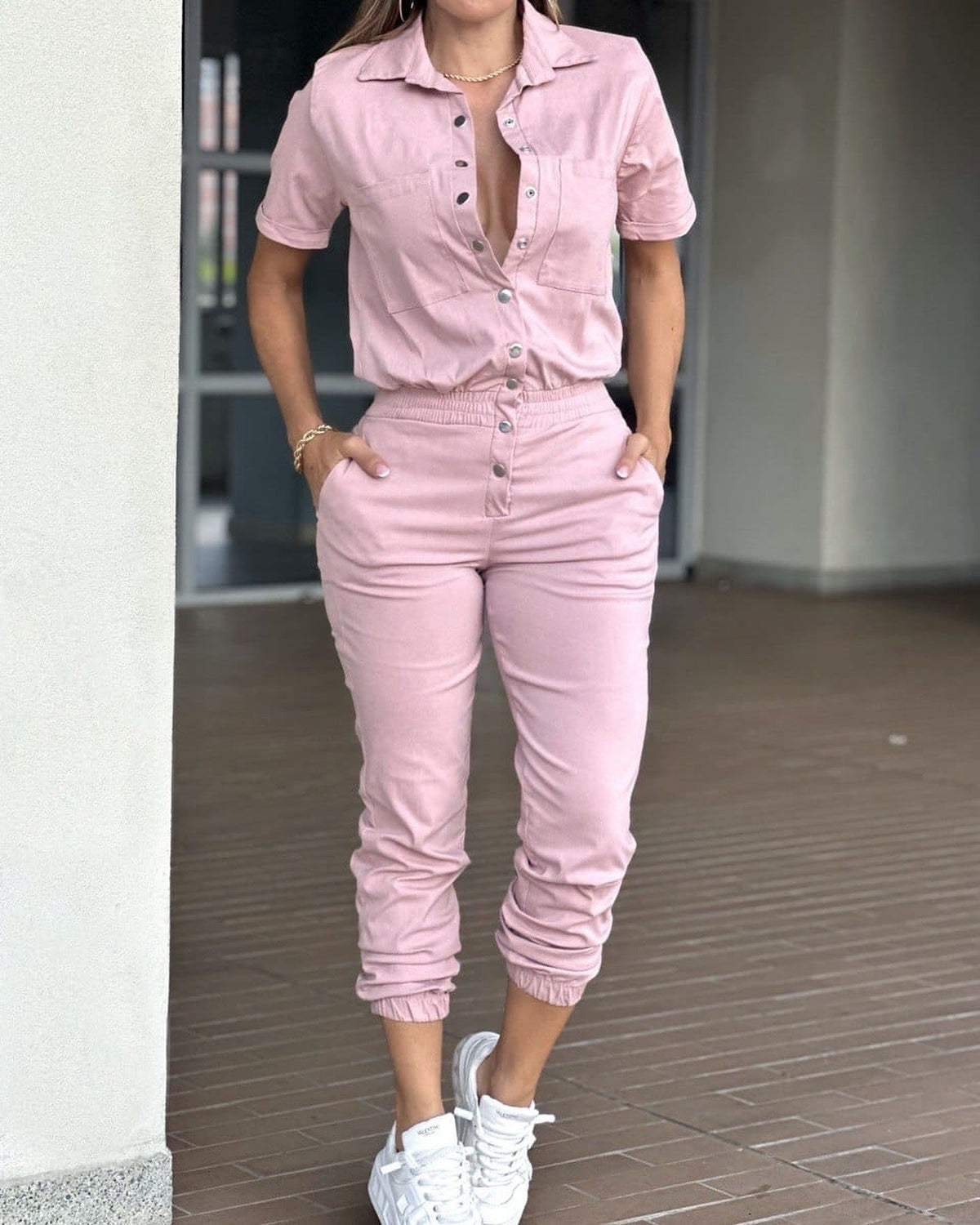 Casual women's ankle-tied jumpsuit with collar, pocket, elastic waist, and button details by Plush Fashion Hub.