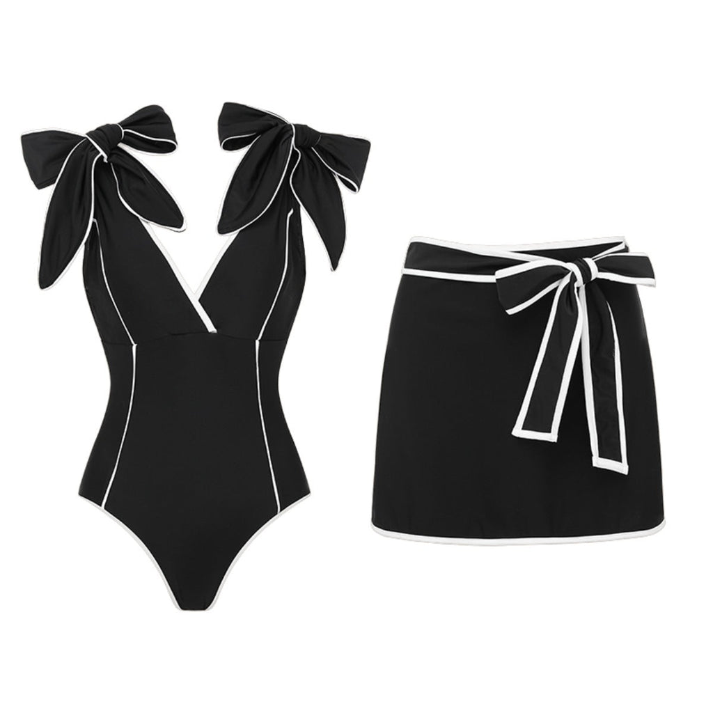 Black and white matching swimsuit bottoms with a bow detail and white skirt, designed for women by Plush Fashion Hub.