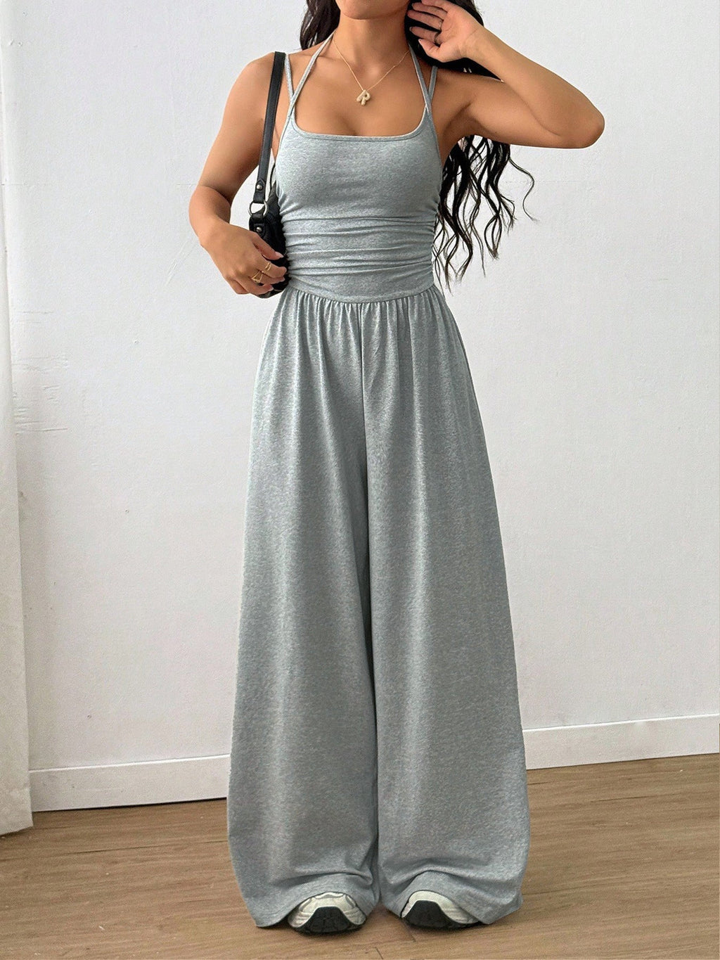 Casual women's summer wide-leg jumpsuit with wrapped chest and nipped waist, from Plush Fashion Hub, featuring suspenders and loose fit.