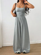 Casual women's summer wide-leg jumpsuit with wrapped chest and nipped waist, from Plush Fashion Hub, featuring suspenders and loose fit.