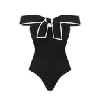 Black and white matching swimsuit bottoms with a sweet girl bow detail, featuring a white skirt, by Plush Fashion Hub.