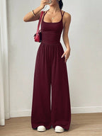 Casual women’s summer jumpsuit with wide-leg style, wrapped chest, nipped waist, and suspenders by Plush Fashion Hub.