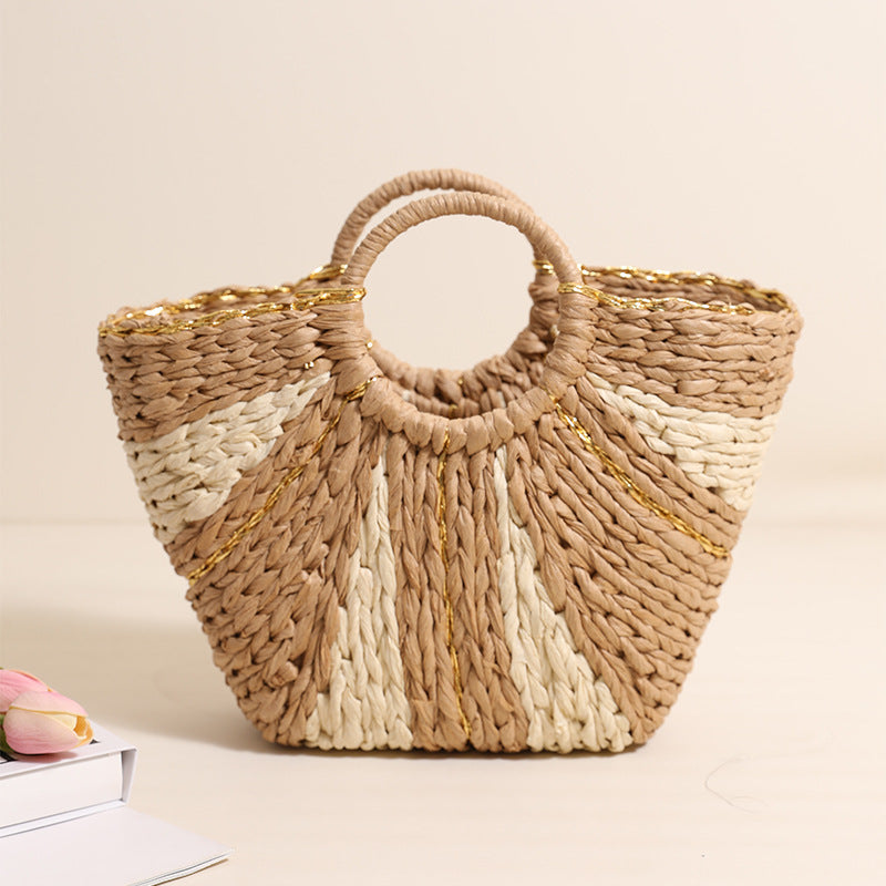 Large straw-weaved tote bag by Bella Mia with contrast handles, ideal for beach, vacation, or shopping, featuring a spacious design.