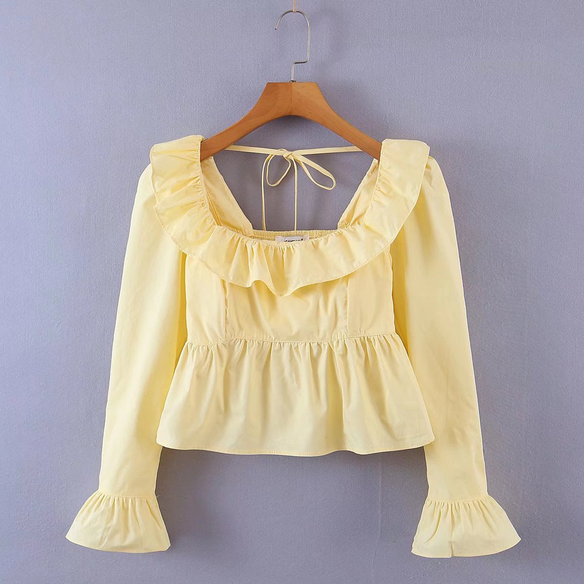 Bella Mia Summer Wind women’s long sleeve ruffled shirt in solid color, stylish top with feminine ruffle details.