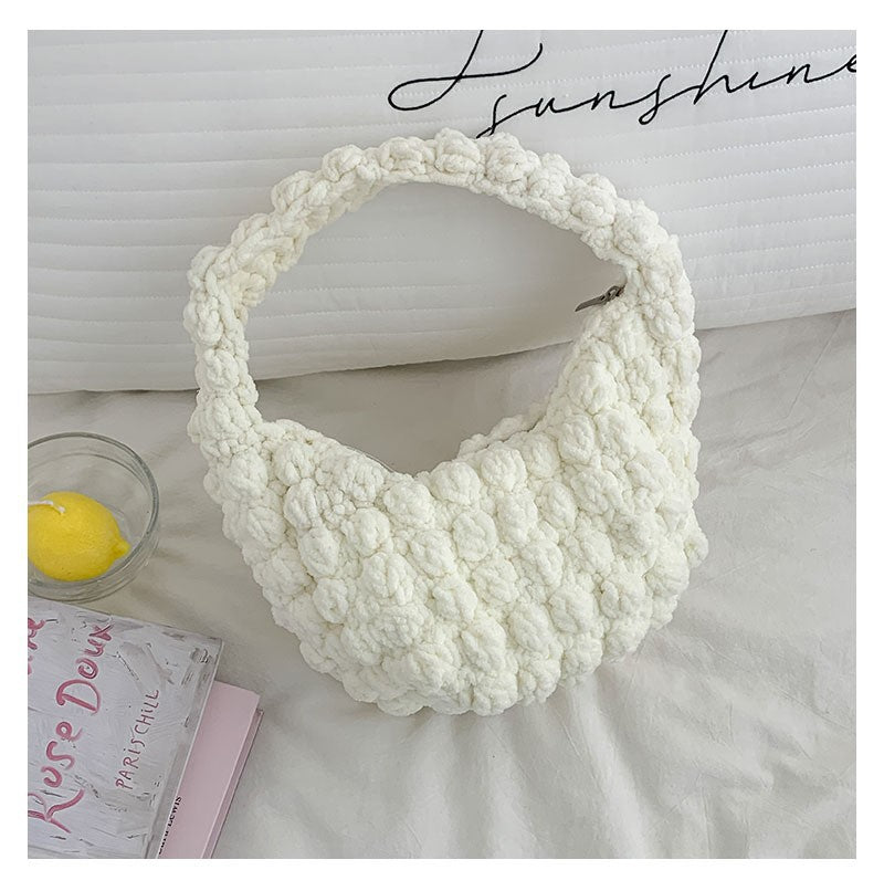Handmade crochet straw beach bag by Bella Mia featuring a solid color, hand carry style perfect for seaside vacations.