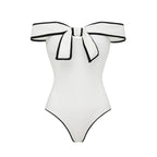 Black and white matching swimsuit bottoms with a bow, featuring a white skirt, designed for women by Plush Fashion Hub.
