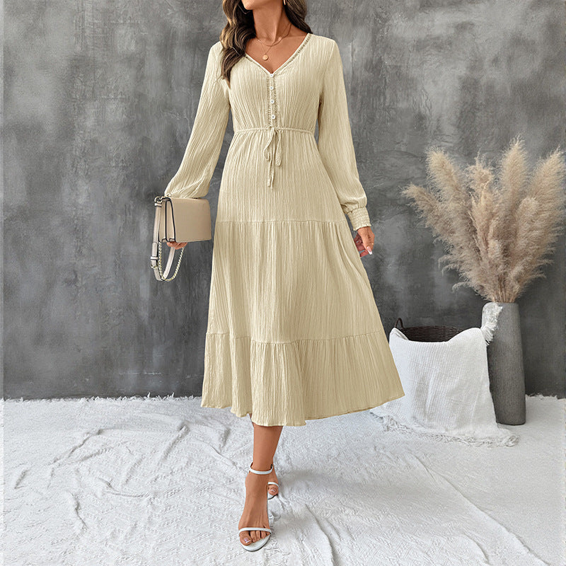 Elegant long sleeve pleated V-neck solid color dress by Bella Mia, featuring a flowing design and sophisticated style.
