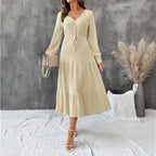 Elegant long sleeve pleated V-neck solid color dress by Bella Mia, featuring a flowing design and sophisticated style.