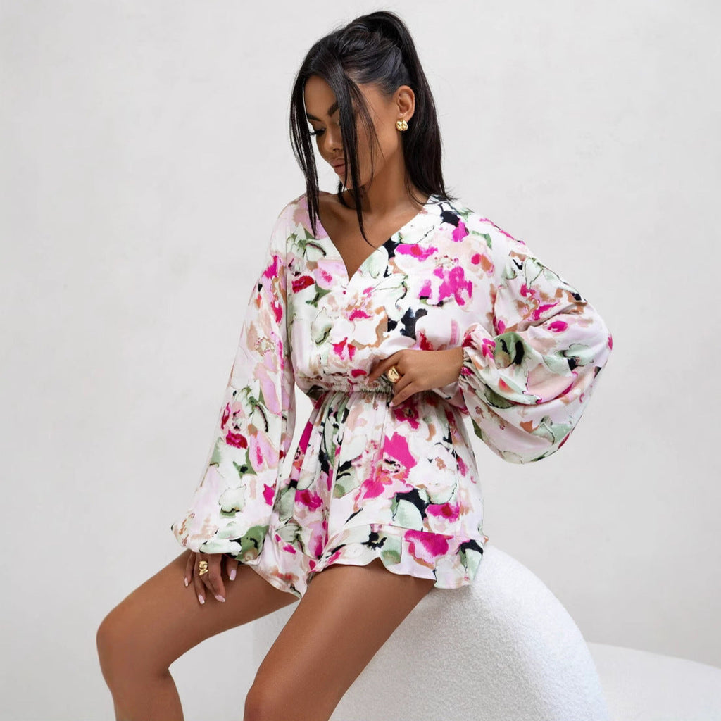 Women’s summer V-neck printed long sleeve jumpsuit by Bella Mia featuring waist trimming and ruffle details.