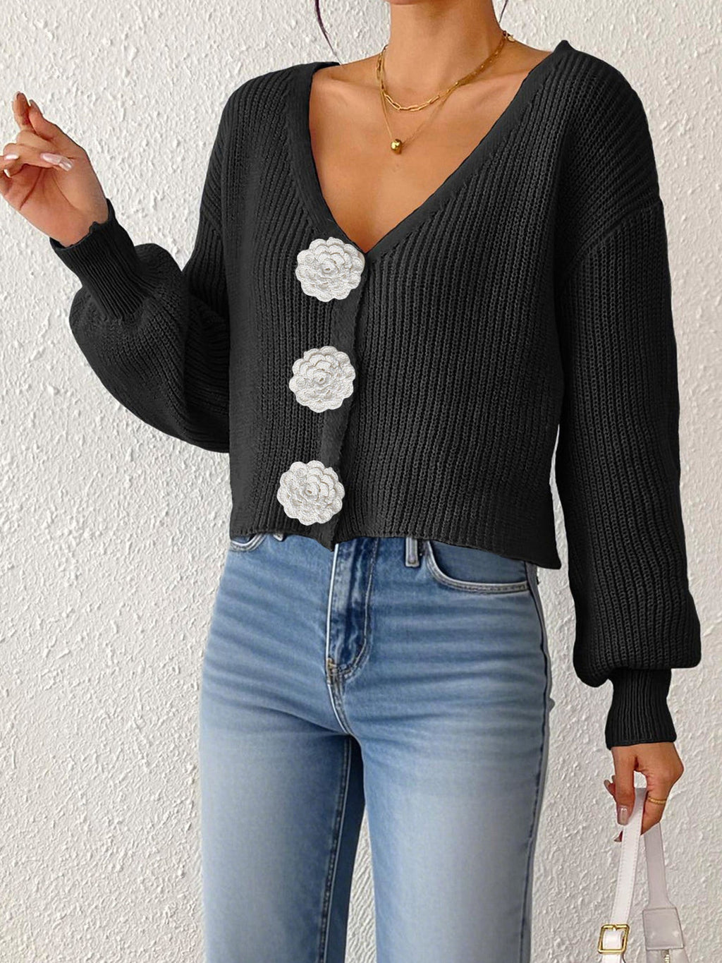 Women's knitted sweater top by Bella Mia with floral buttons, short coat style, and hand-hook decorative details.