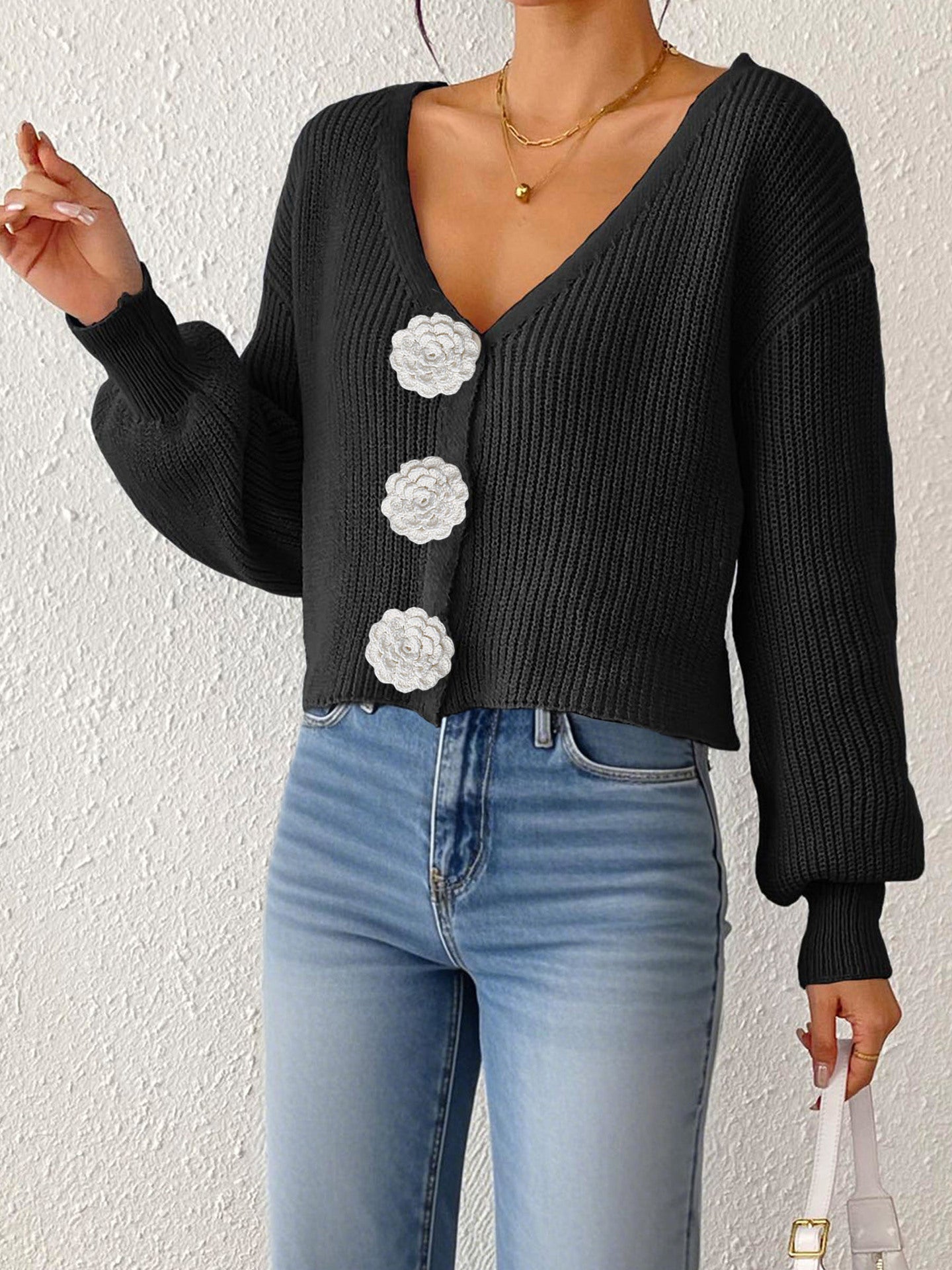 Women's knitted sweater top by Bella Mia with floral buttons, short coat style, and hand-hook decorative details.