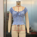 French plaid summer women's top from Plush Fashion Hub with puff sleeves, lace edges, and a short, sweet design.