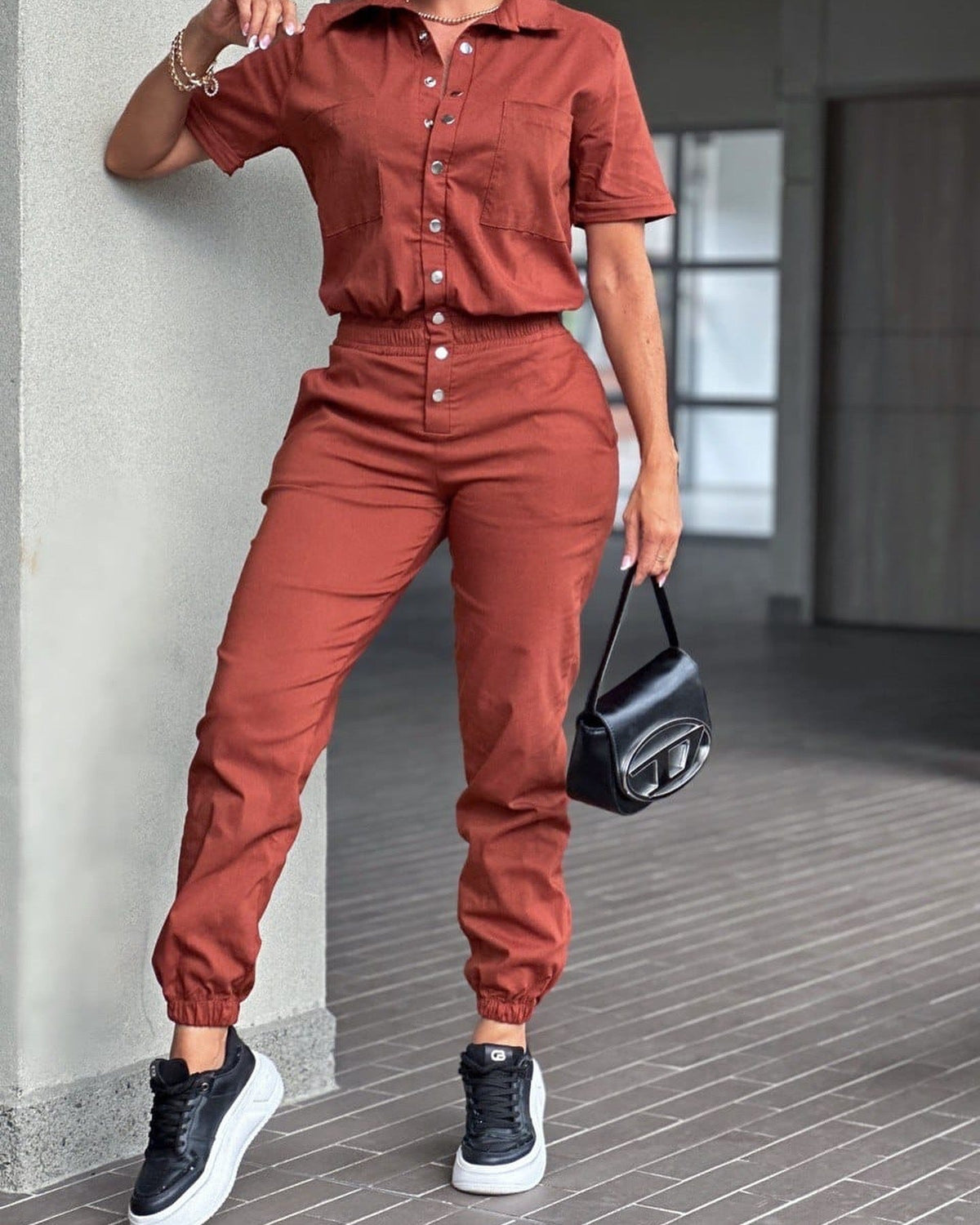 Casual women's ankle-tied jumpsuit with collar, pocket, elastic waist, and button details from Plush Fashion Hub.