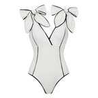 Black and white girls' swimsuit bottoms with a cute bow and matching white skirt, by Plush Fashion Hub.