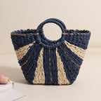 Large straw-weaved Bella Mia portable bag with contrast color handles, ideal for beach, vacation, or vegetable shopping.