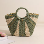 Large straw-weaved tote bag by Bella Mia with contrast handles, perfect for beach, vacation, or carrying vegetables.