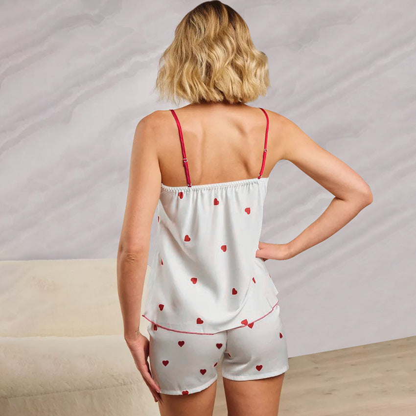 Bella Mia satin two-piece pajama set featuring heart-print suspender shorts and a matching top for spring homewear.