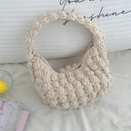 Handmade solid color crocheted straw bag by Bella Mia, portable beach bag with hand carry design for seaside vacations.