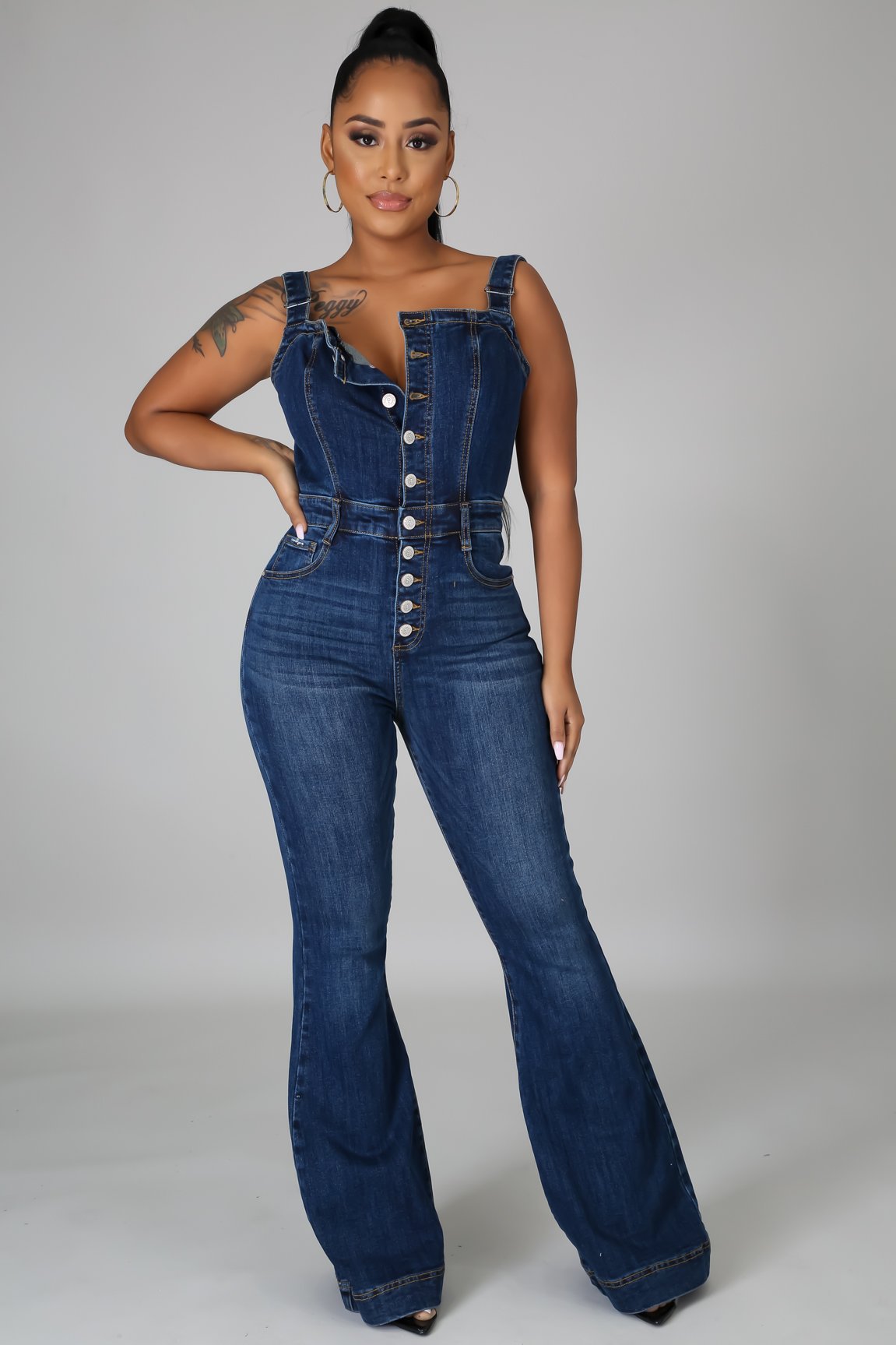 Casual women's denim jumpsuit with wide-leg pants and sexy strap details, designed by Plush Fashion Hub.