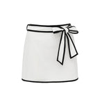 Black and white matching swimsuit bottoms with a bow, featuring a white skirt detail, designed for women by Plush Fashion Hub.