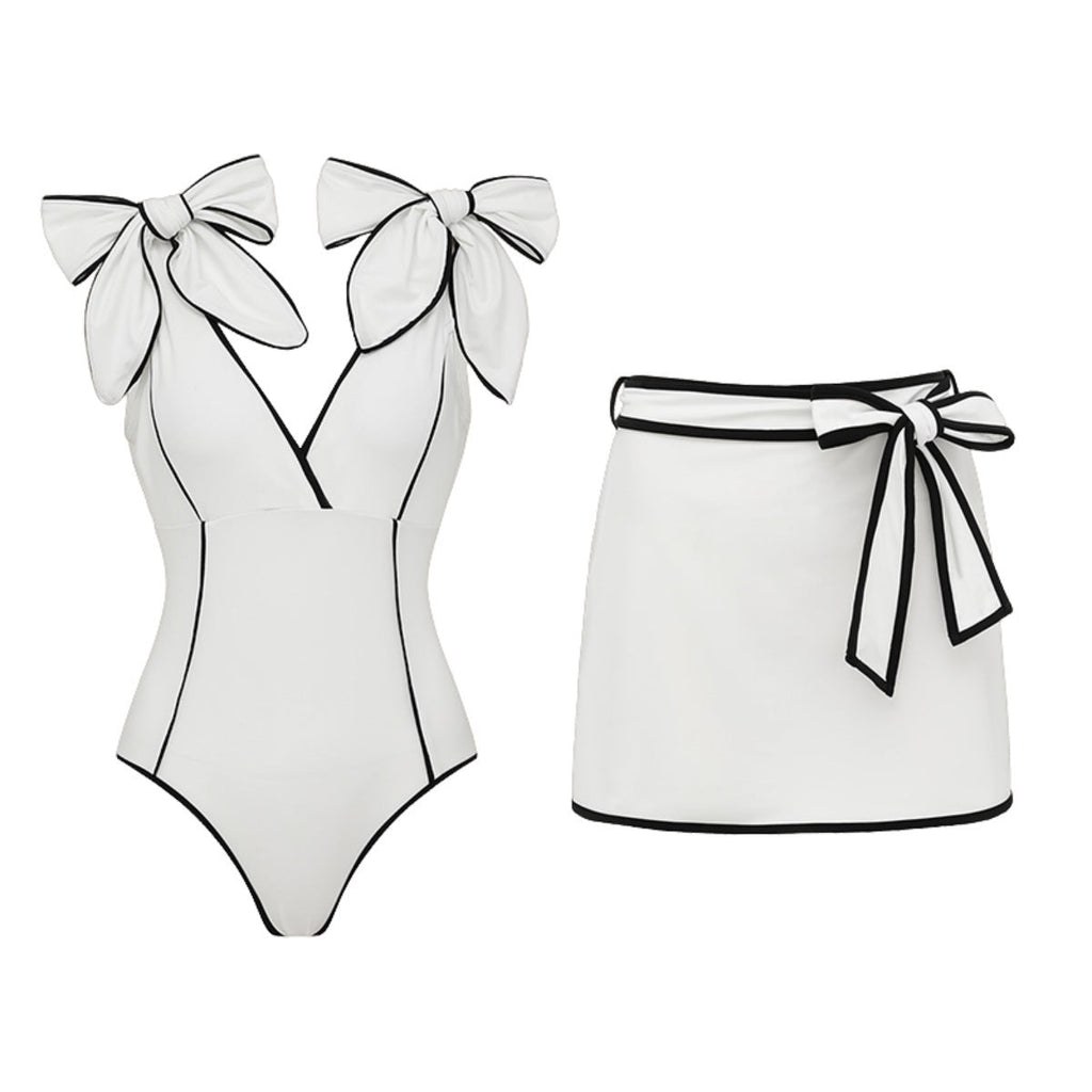 Black and white matching swimsuit bottoms with a bow, featuring a white skirt, designed for women by Plush Fashion Hub.