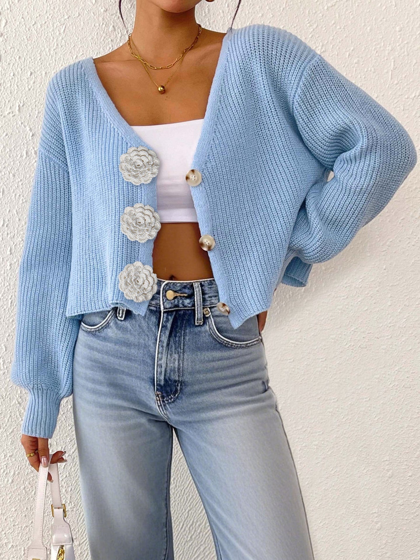 Women’s knitted floral cardigan by Bella Mia, short hipster sweater with decorative buttons and hand hook details.