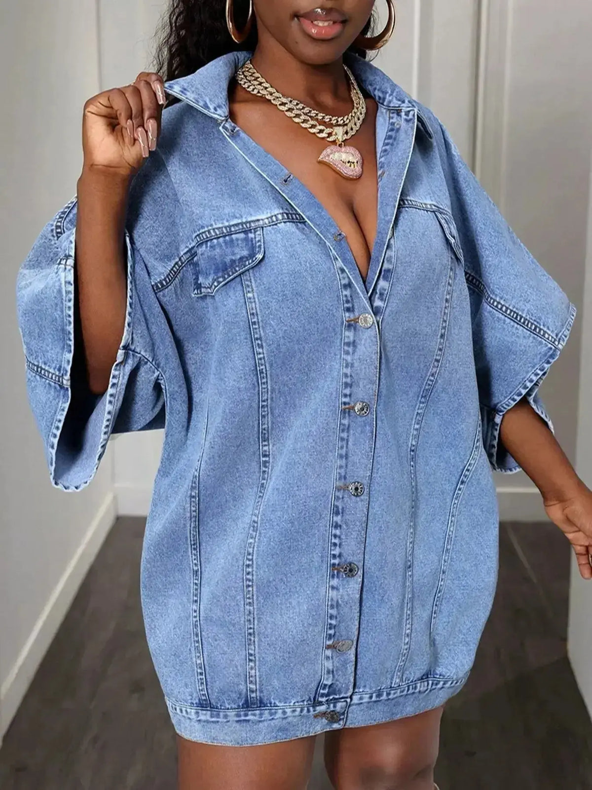 Women's oversized denim button-down shirt with batwing sleeves by Plush Fashion Hub, featuring a relaxed fit and classic design.