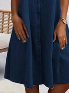 Plus size button-front short sleeve denim dress by Trendsi, featuring a flattering casual midi style with classic denim fabric.