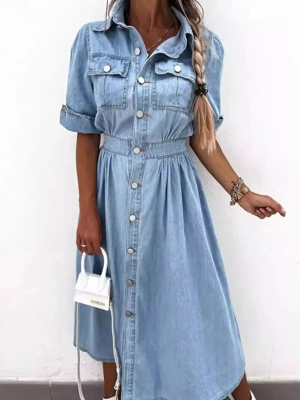 Plus size denim shirt dress with roll-up sleeves and front pockets, stylish and casual by Trendsi.