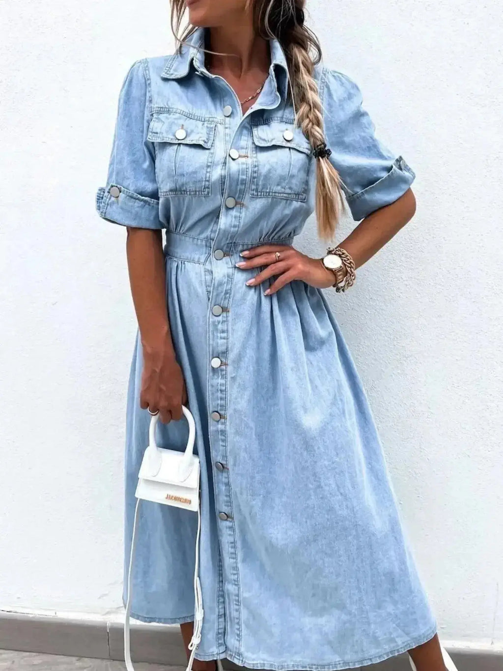Plus size denim shirt dress with roll-up sleeves and front pockets, stylish and casual by Trendsi.