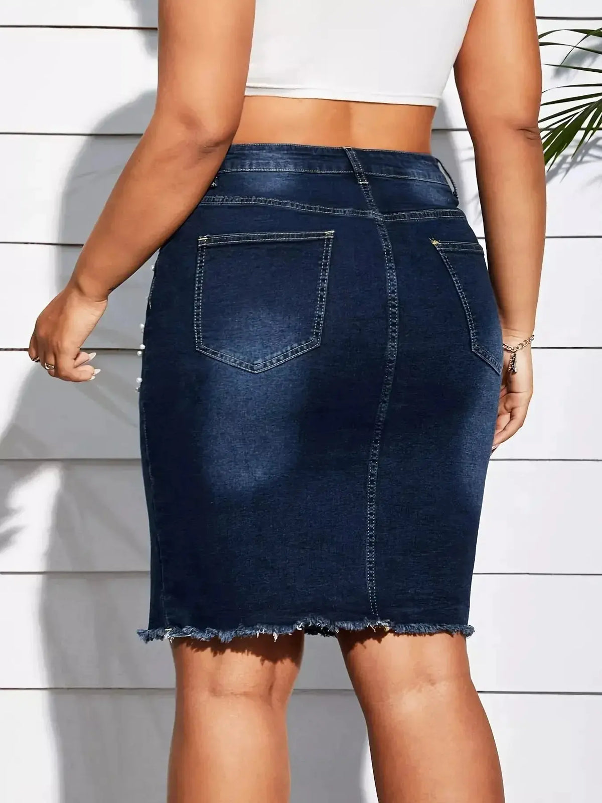 Plus size pearl-embellished frayed hem denim skirt by Plush Fashion Hub, showcasing intricate pearl details and trendy distressed denim.
