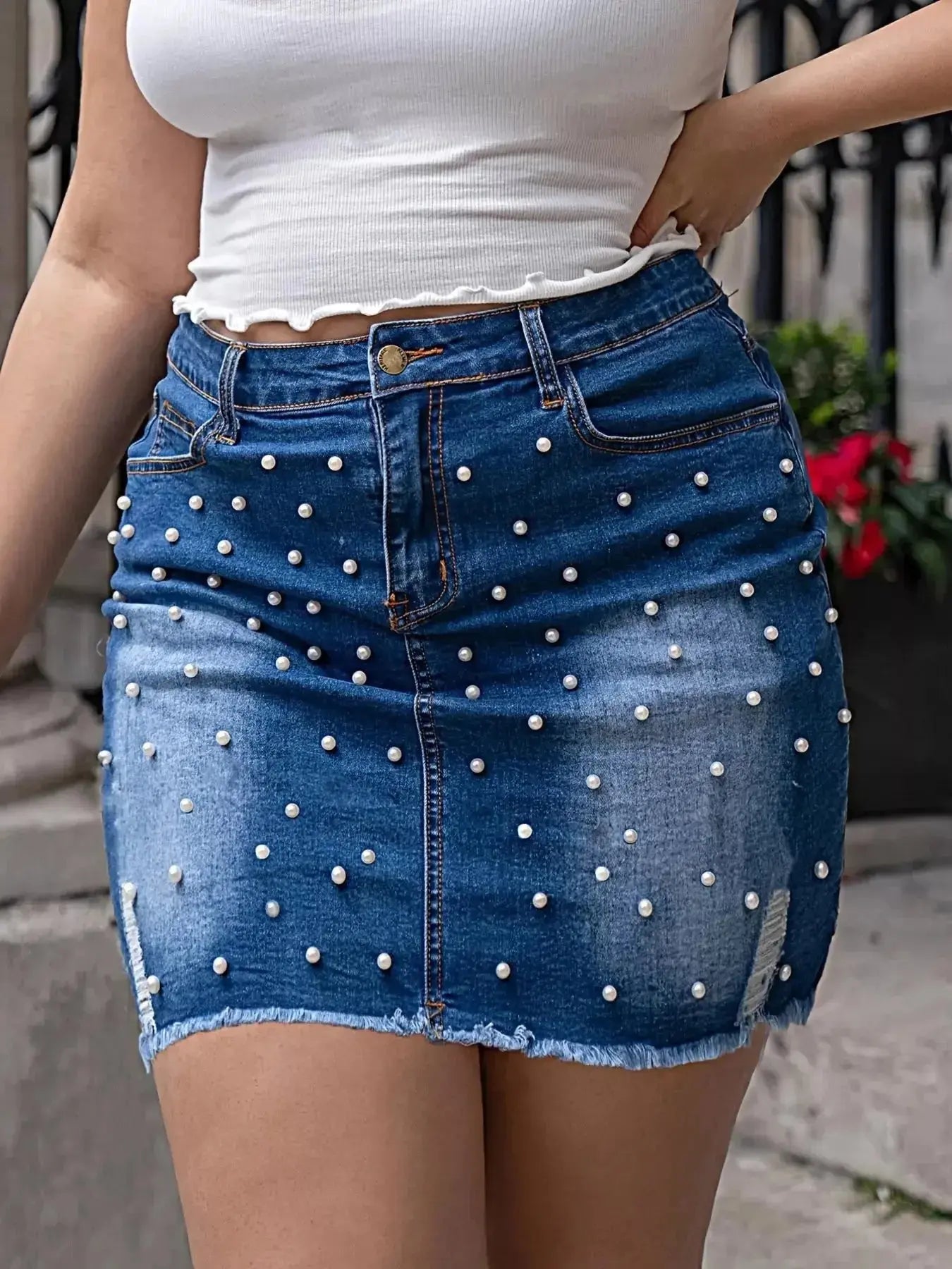 Plus size pearl-embellished raw hem denim skirt by Trendsi, stylish casual midi denim skirt for a fashionable look.