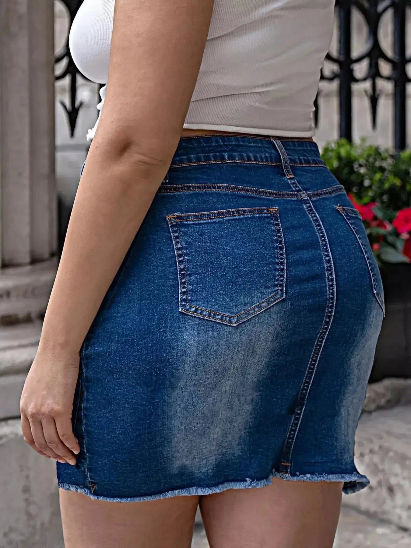 Plus size pearl-embellished raw hem denim skirt by Trendsi, stylish casual midi denim skirt with decorative pearl details.