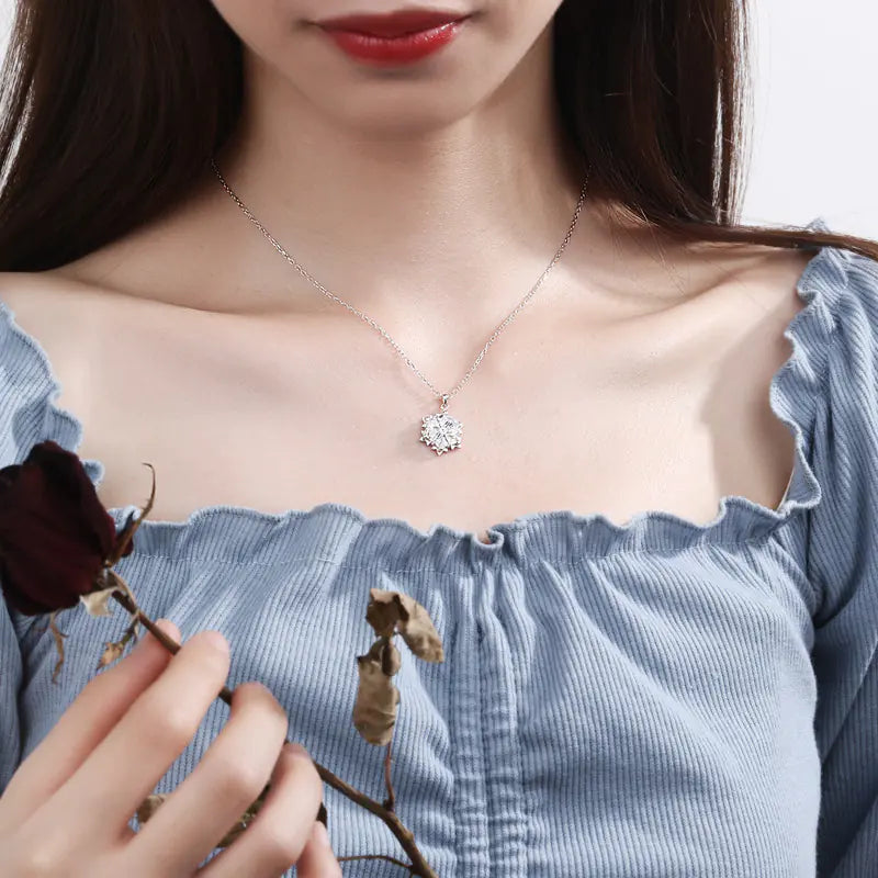 Silver snowflake necklace with diamond pendant featuring intricate design, from Plush Fashion Hub, on a sleek chain.