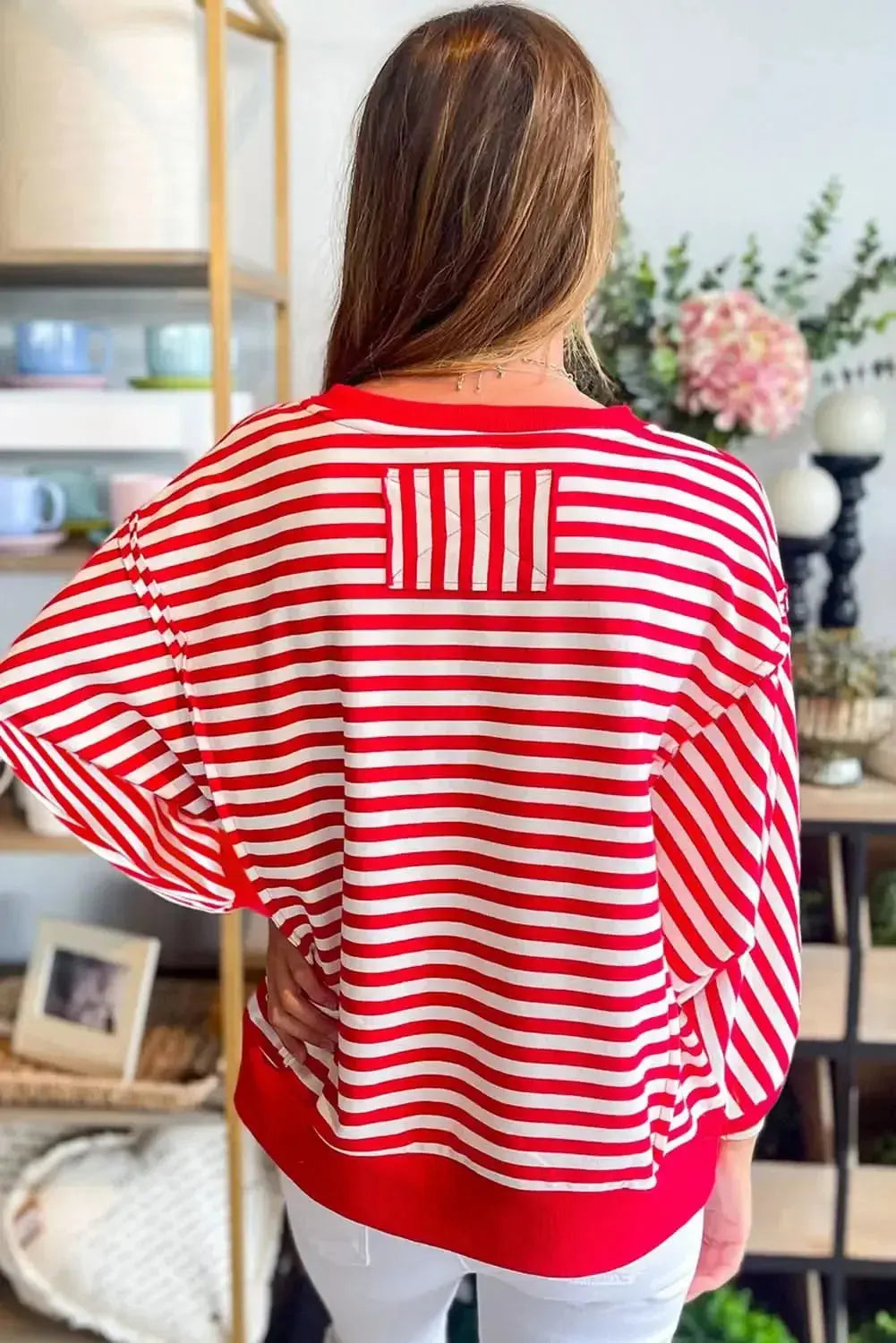 Red striped drop shoulder long sleeve top with exposed seams from Plush Fashion Hub, featuring relaxed fit and casual style.