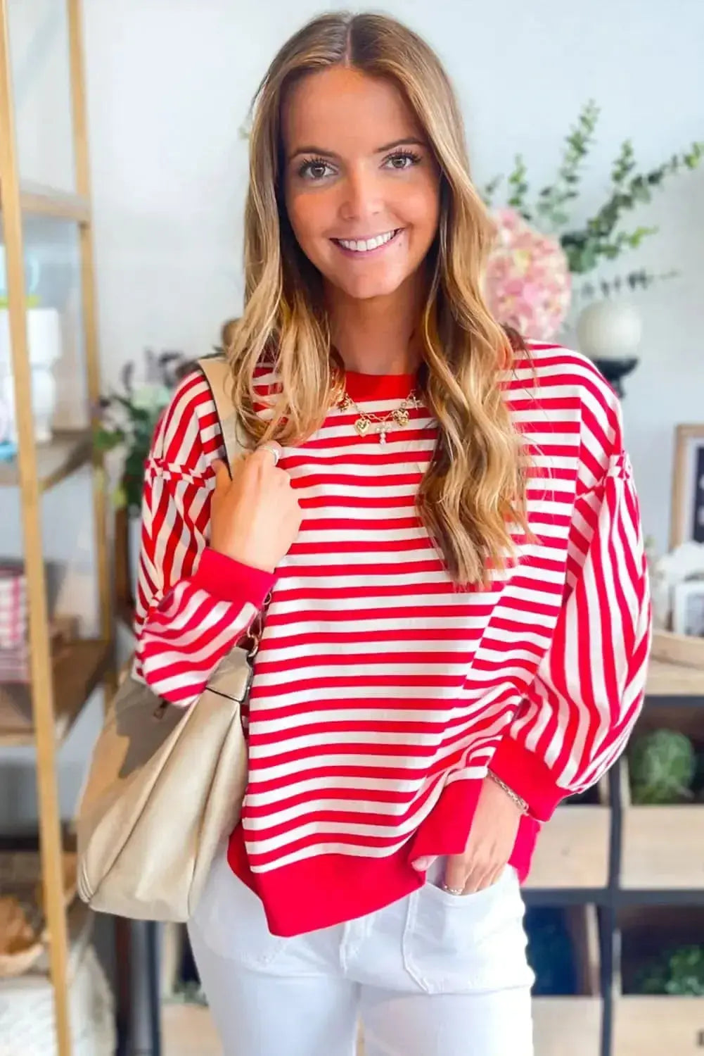 Red striped long sleeve top with drop shoulder and exposed seams by Plush Fashion Hub, casual and stylish for everyday wear.