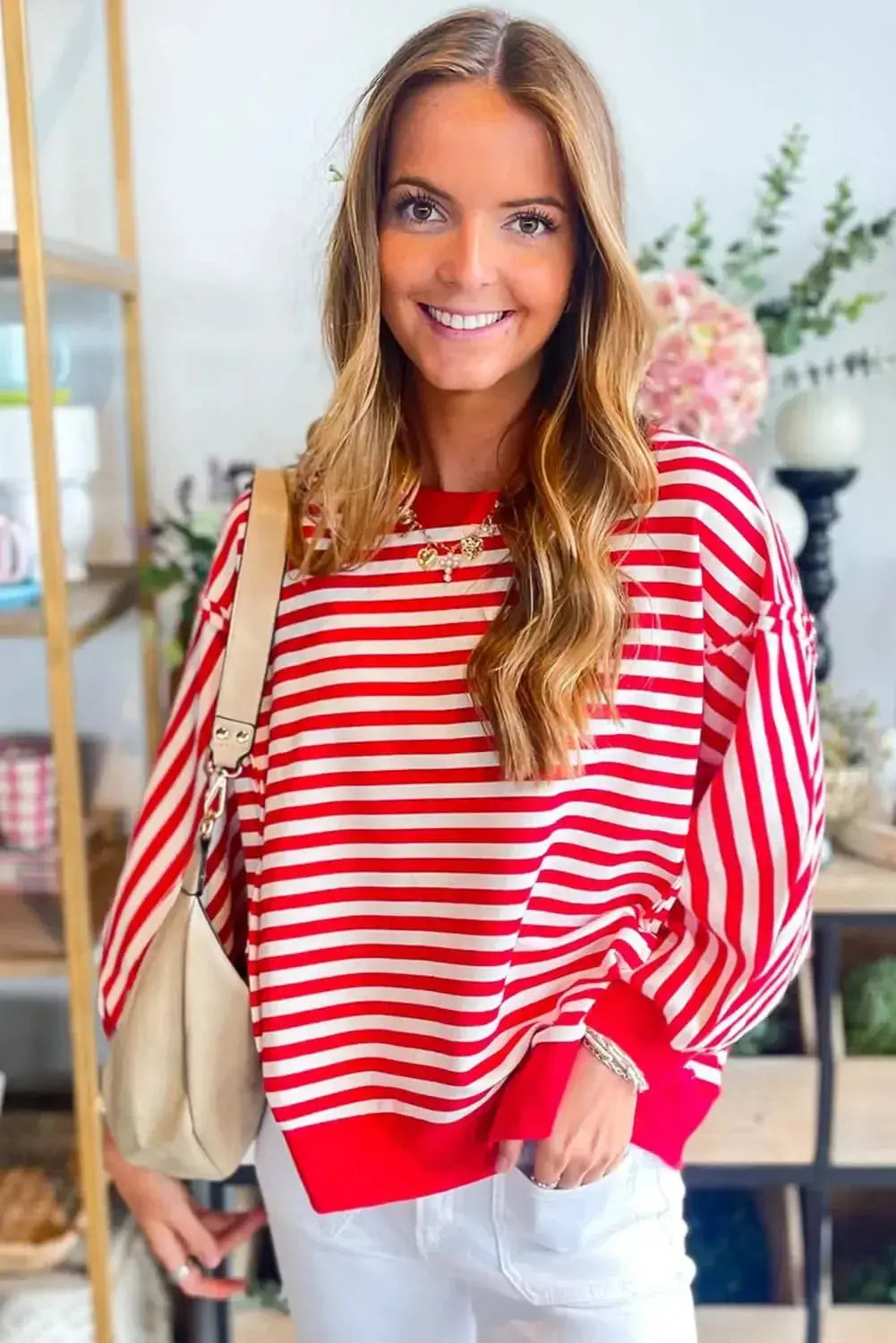 Red striped drop shoulder long sleeve top with exposed seams from Plush Fashion Hub, featuring a relaxed fit and stylish design.