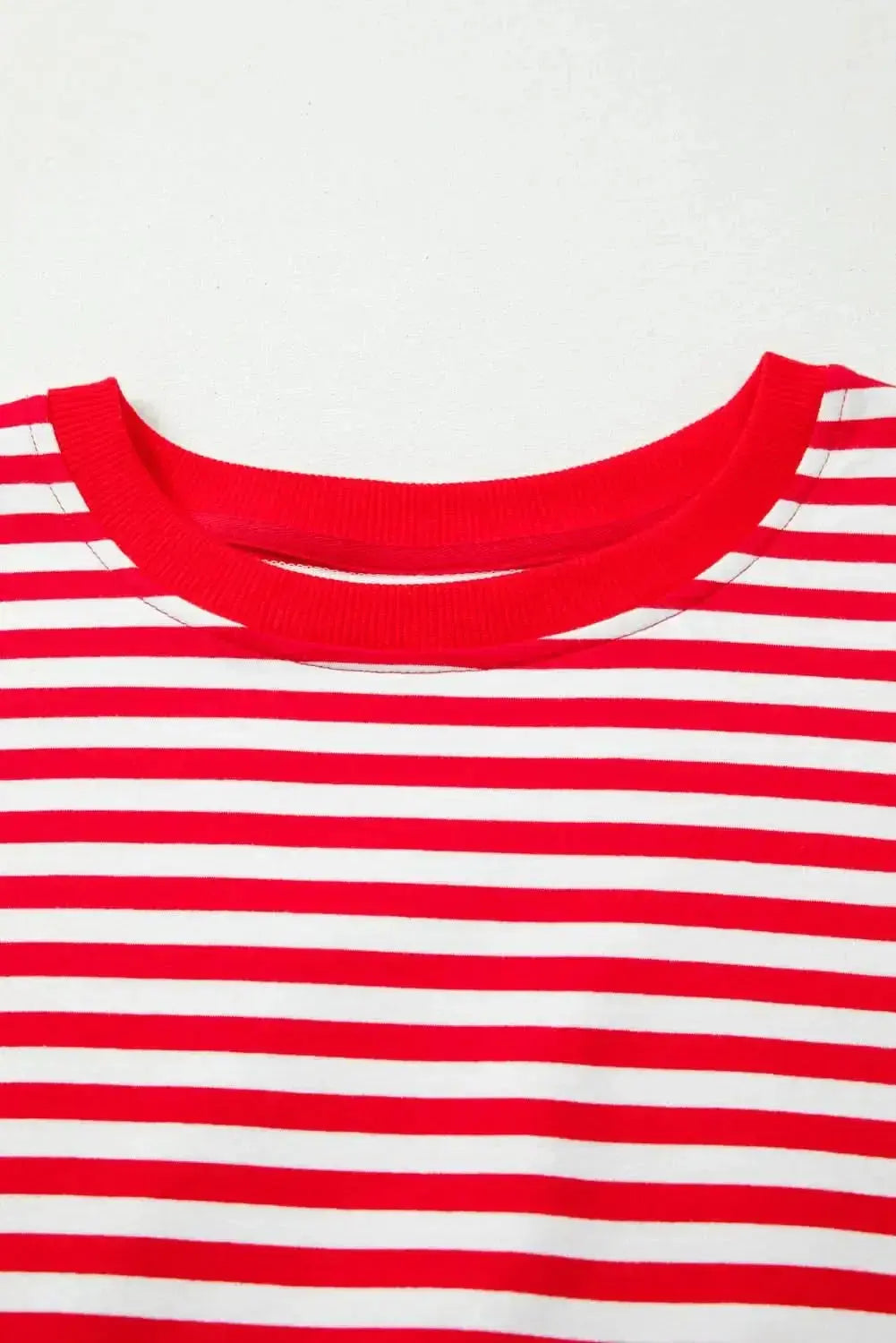 Red striped drop shoulder long sleeve top with exposed seams by Plush Fashion Hub, casual and stylish for everyday wear.
