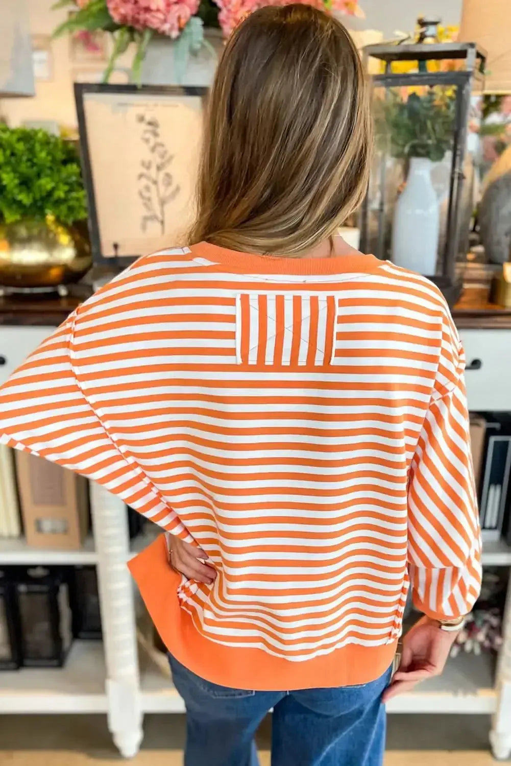 Red striped drop shoulder long sleeve top with exposed seams by Plush Fashion Hub, casual and stylish for everyday wear.