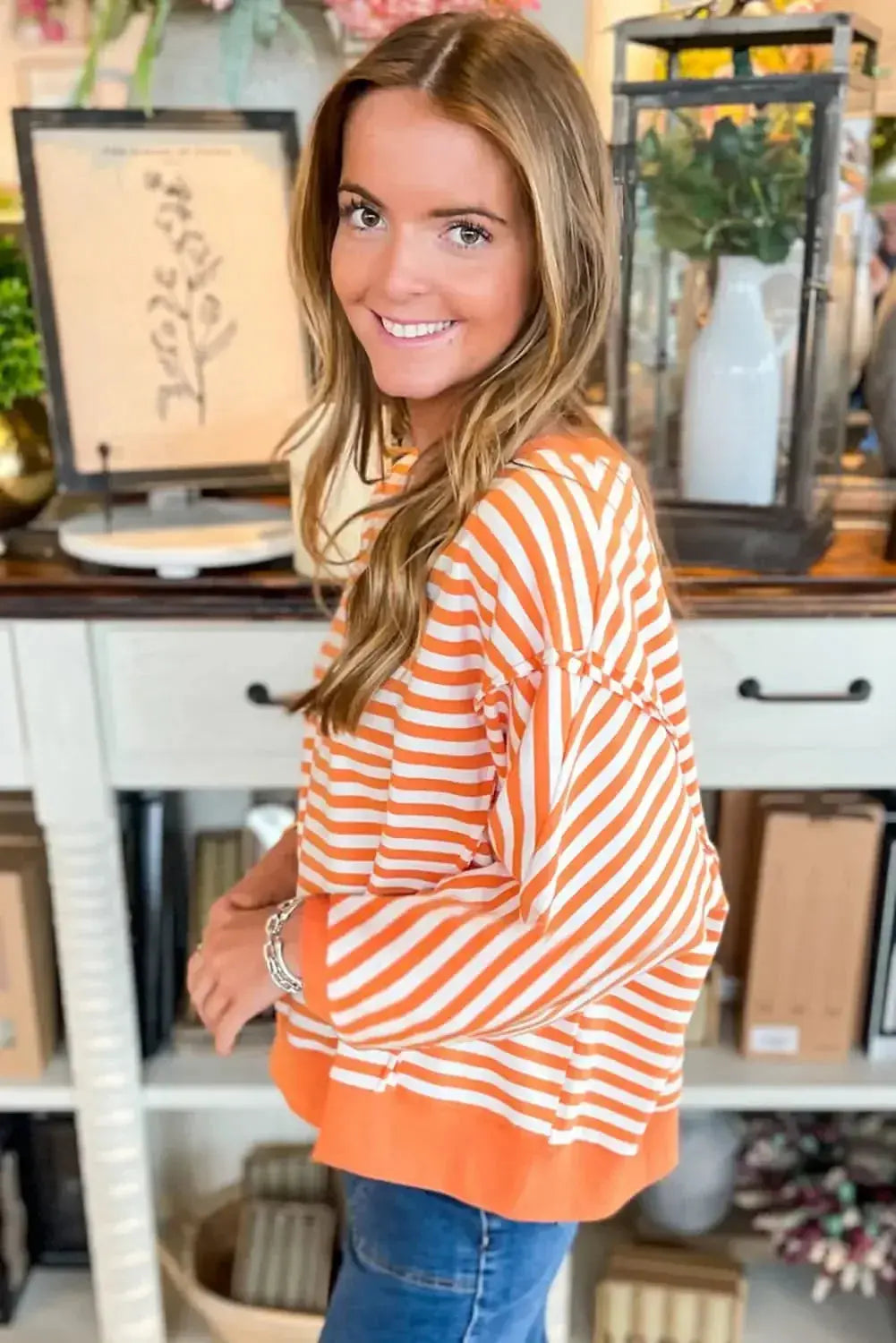 Red striped drop shoulder long sleeve top with exposed seams from Plush Fashion Hub, featuring a relaxed fit and casual style.