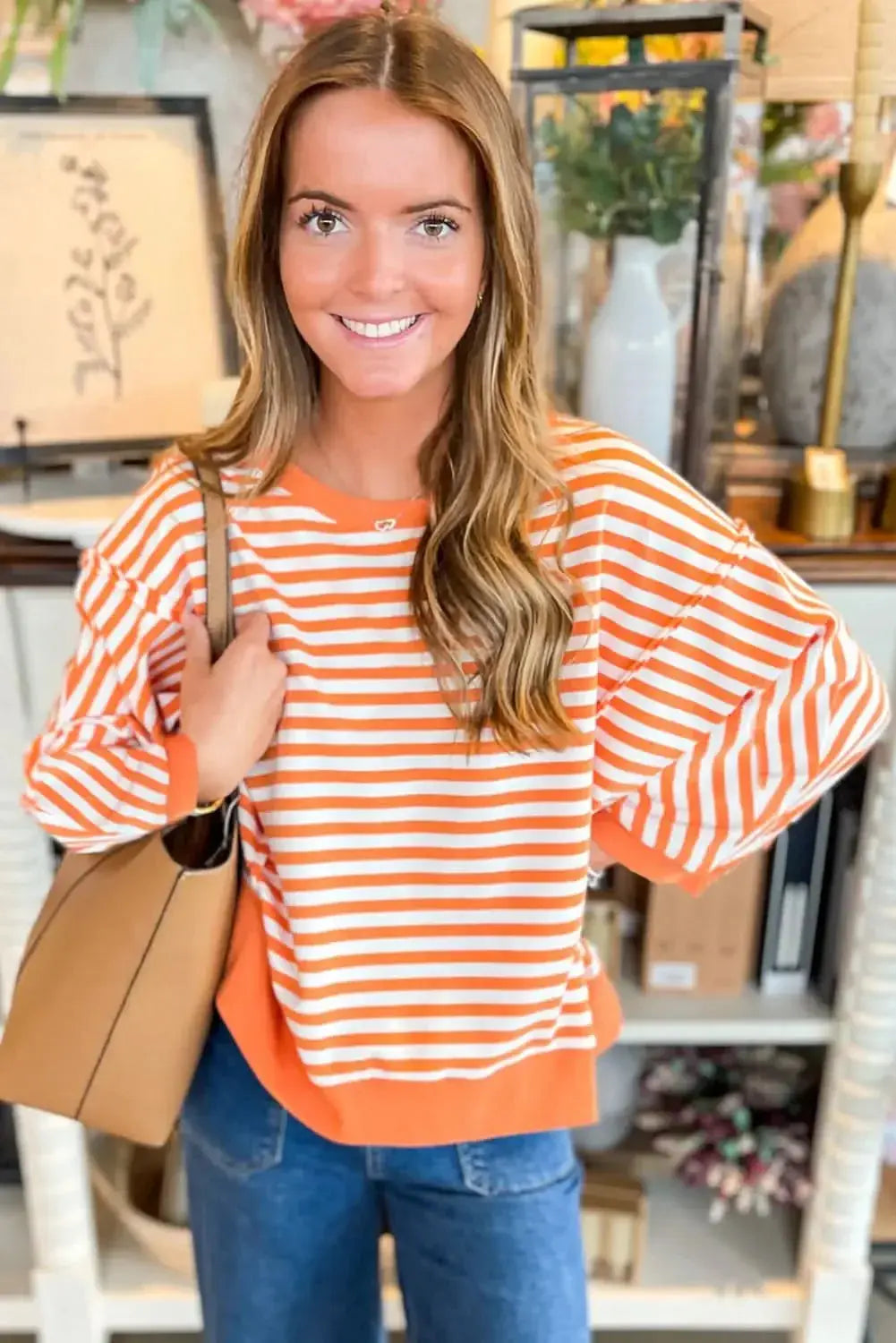 Red striped drop shoulder long sleeve top with exposed seams from Plush Fashion Hub, featuring a relaxed fit and casual style.