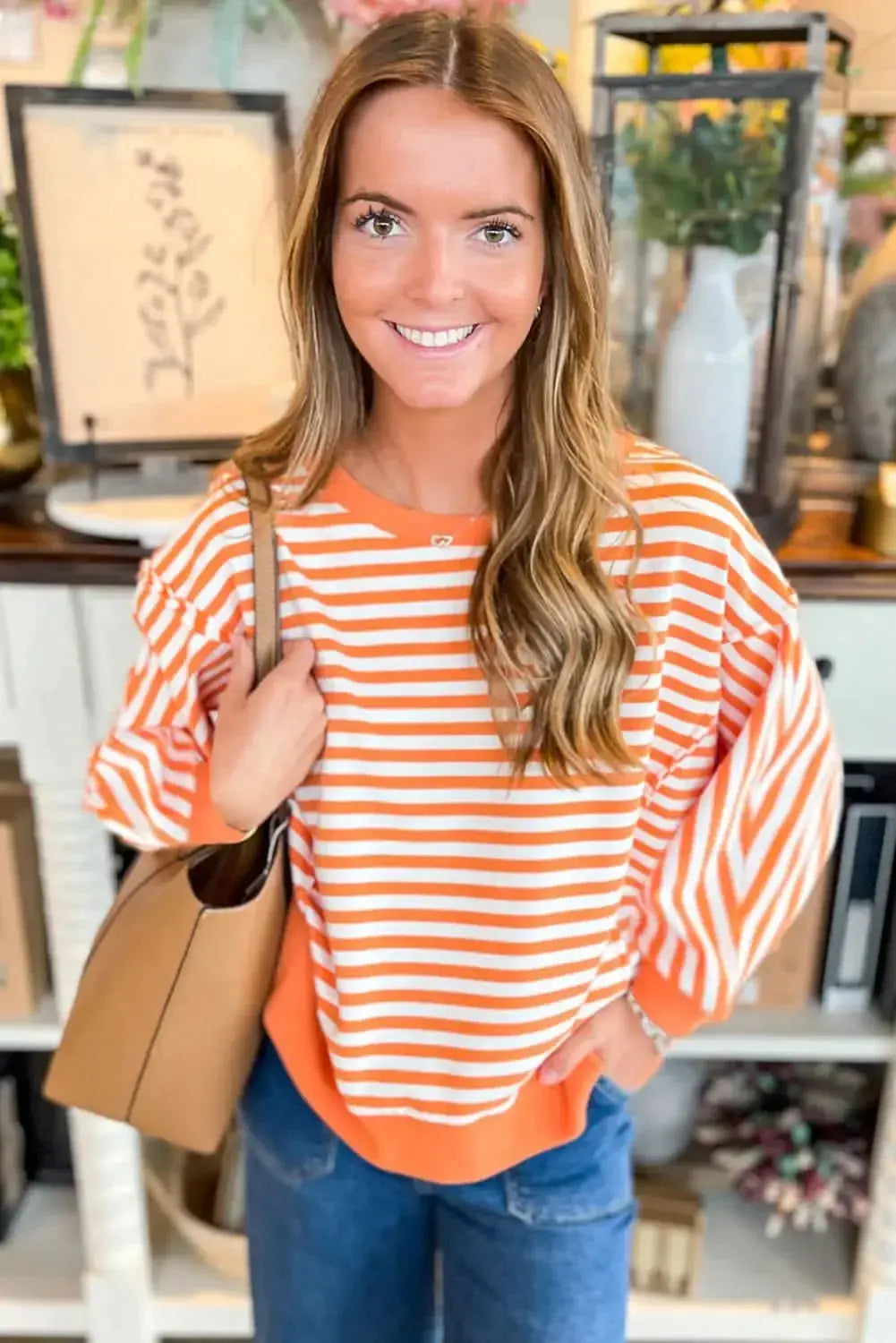 Red striped drop shoulder long sleeve top with exposed seams from Plush Fashion Hub, featuring a relaxed fit and casual style.