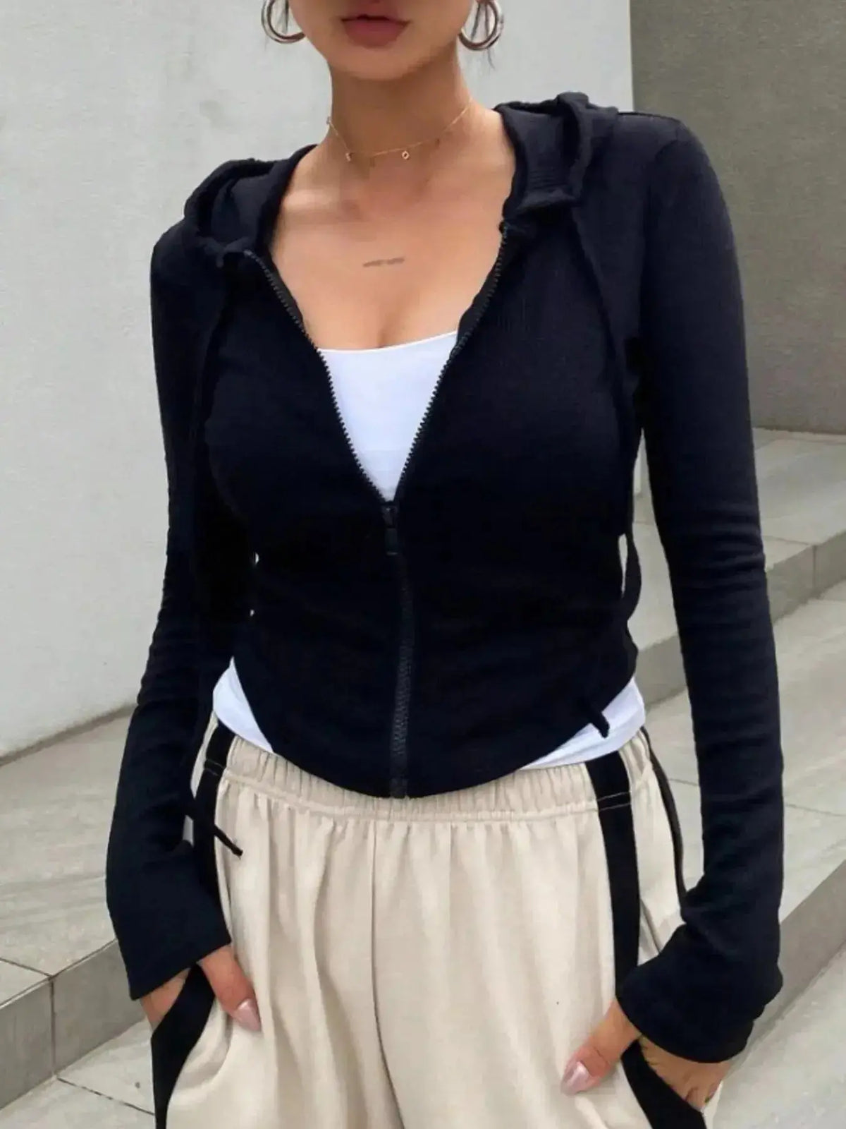 Women's ribbed knit cropped zip-up hoodie jacket by Plush Fashion Hub, featuring a hood and fitted ribbed design.