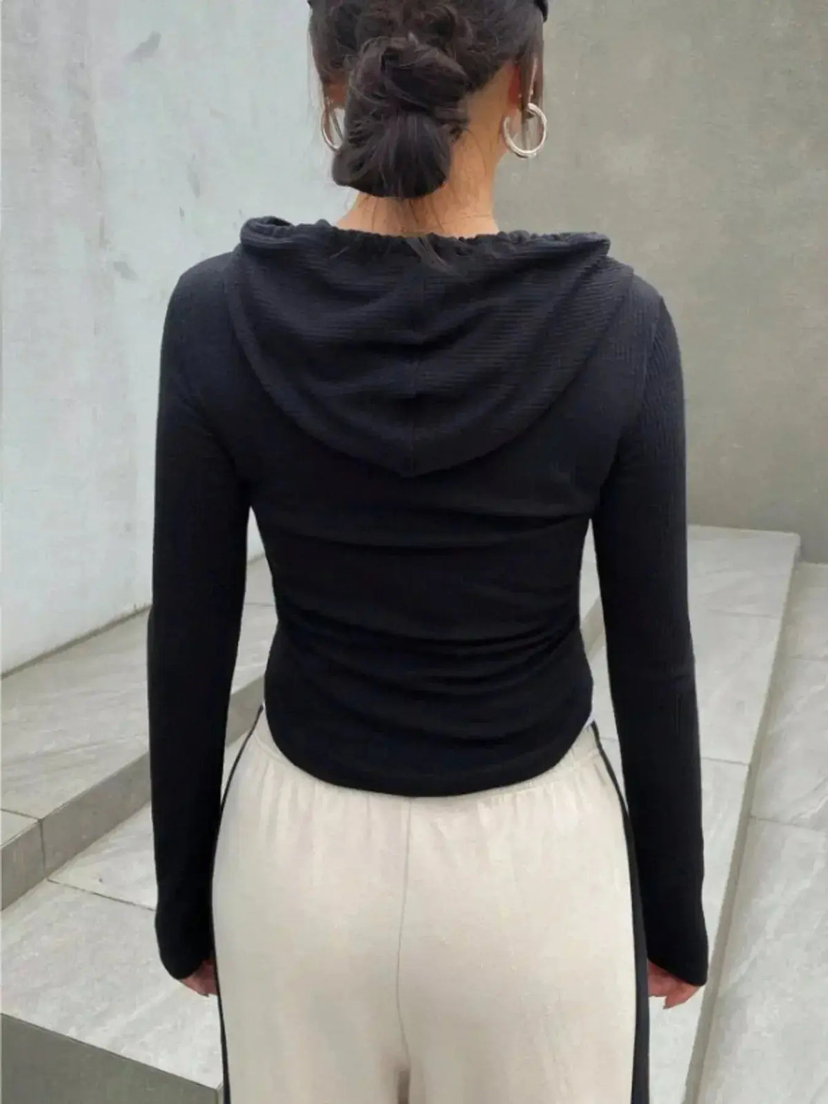 Women's ribbed knit cropped zip-up jacket with hood, plush outerwear by Plush Fashion Hub, displayed on a hanger.