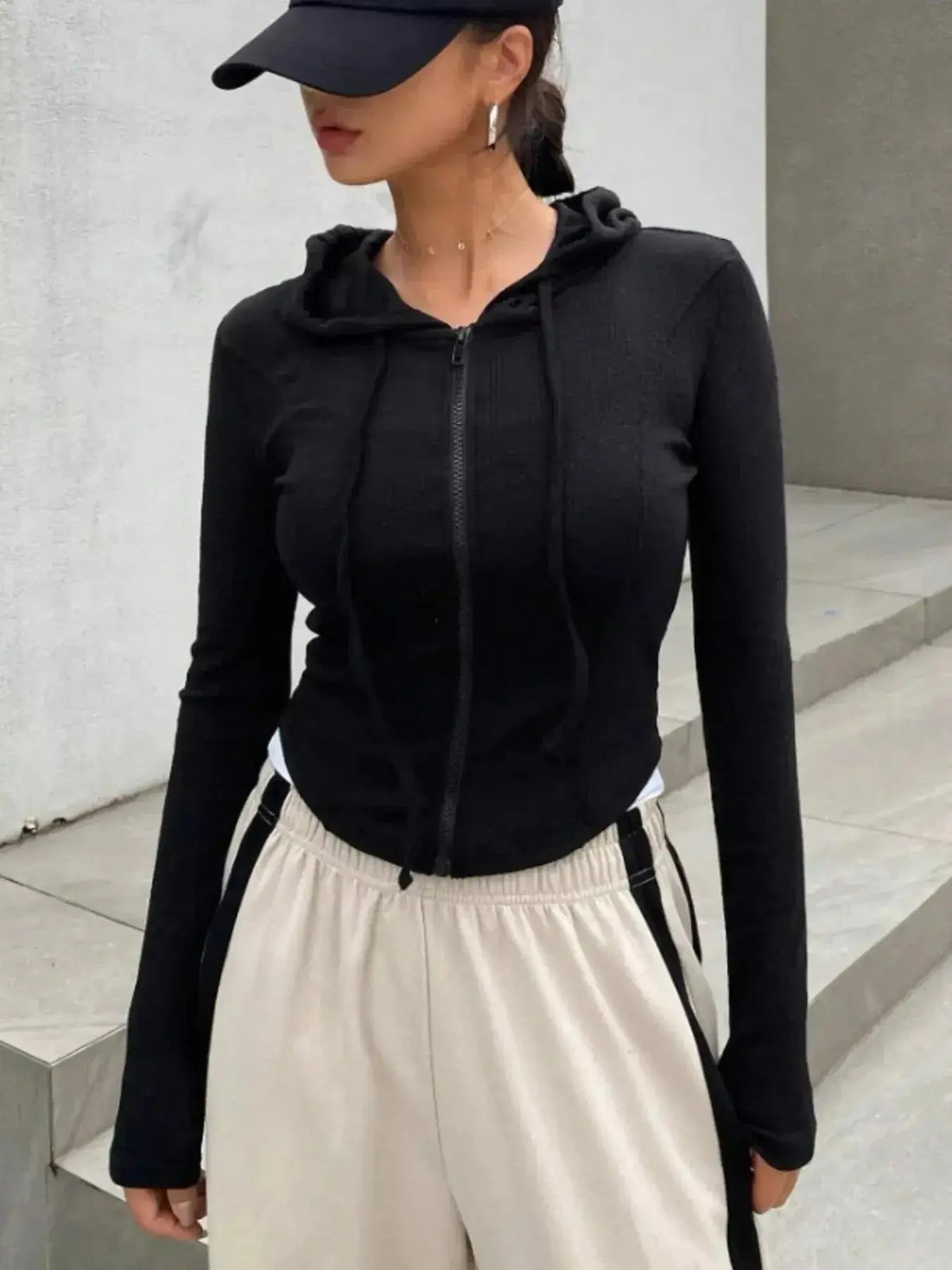 Women's hooded ribbed knit cropped zip-up jacket by Plush Fashion Hub, featuring a stylish outerwear design with a front zipper.
